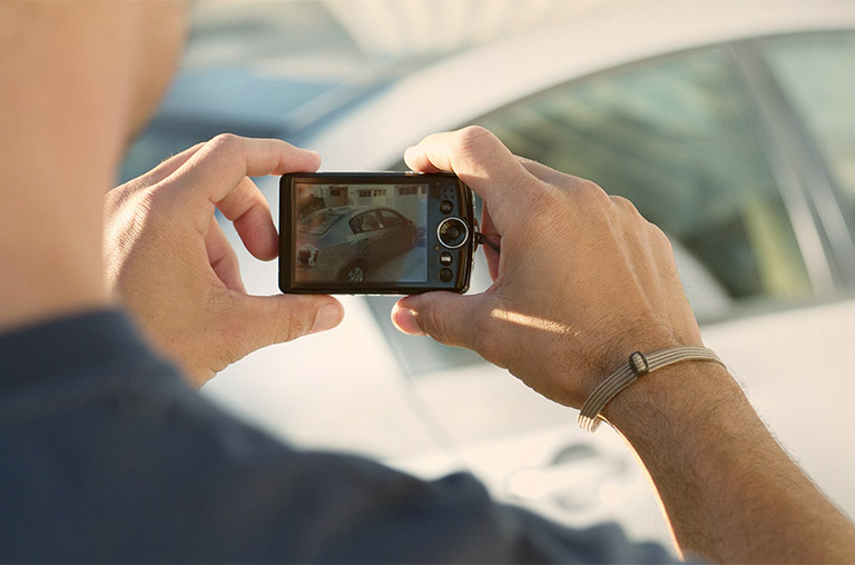 man taking video of a vehicle for sale