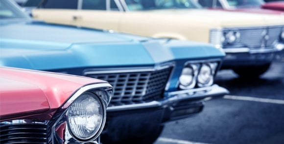 classic cars on a dealership lot